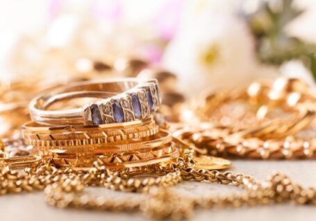 Stack of gold jewelry - rings, bracelets, necklaces